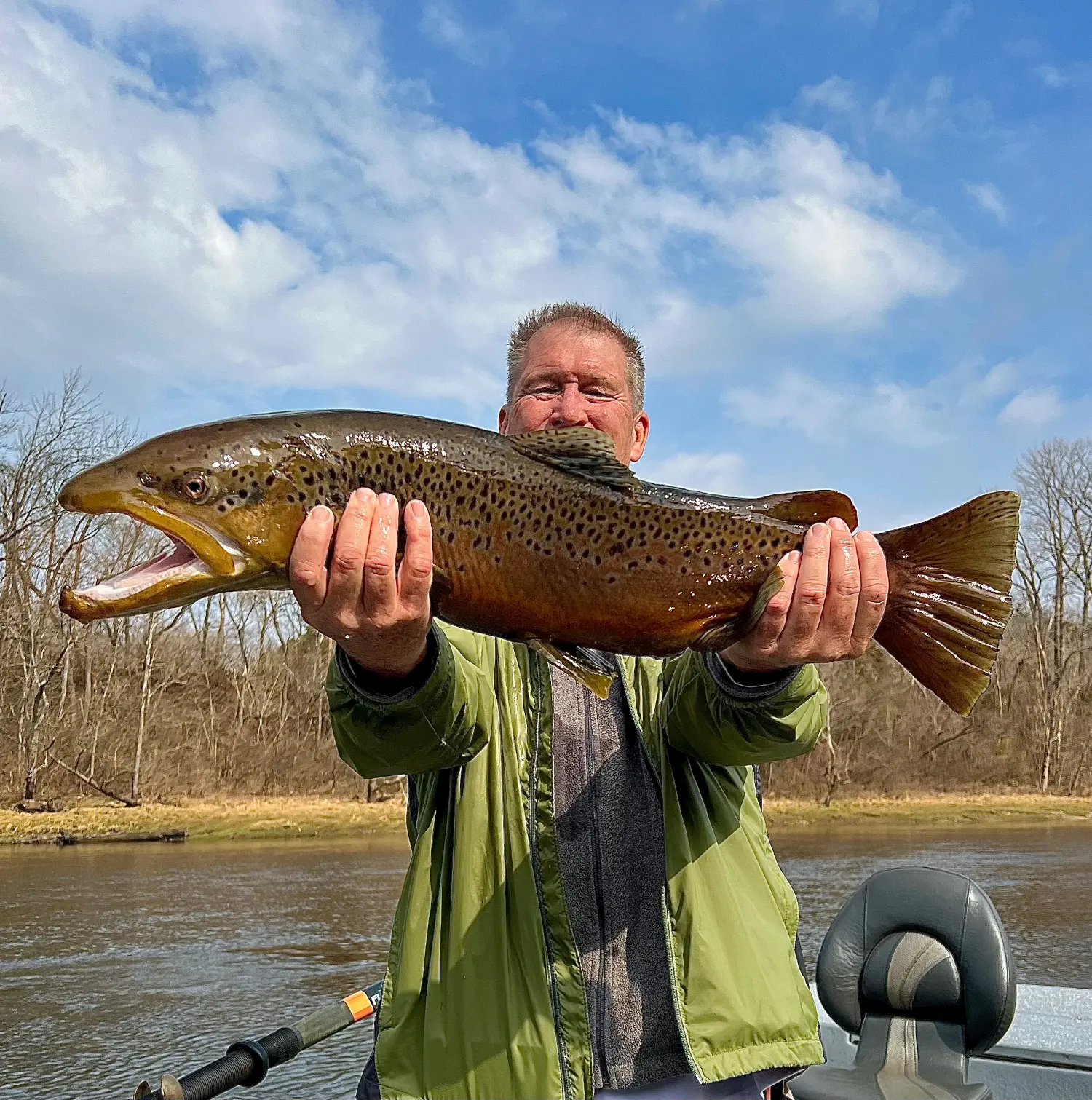 Customer and friend holding a huge White River Brown Trout caught on an Arkansas guided fly fishing trip.