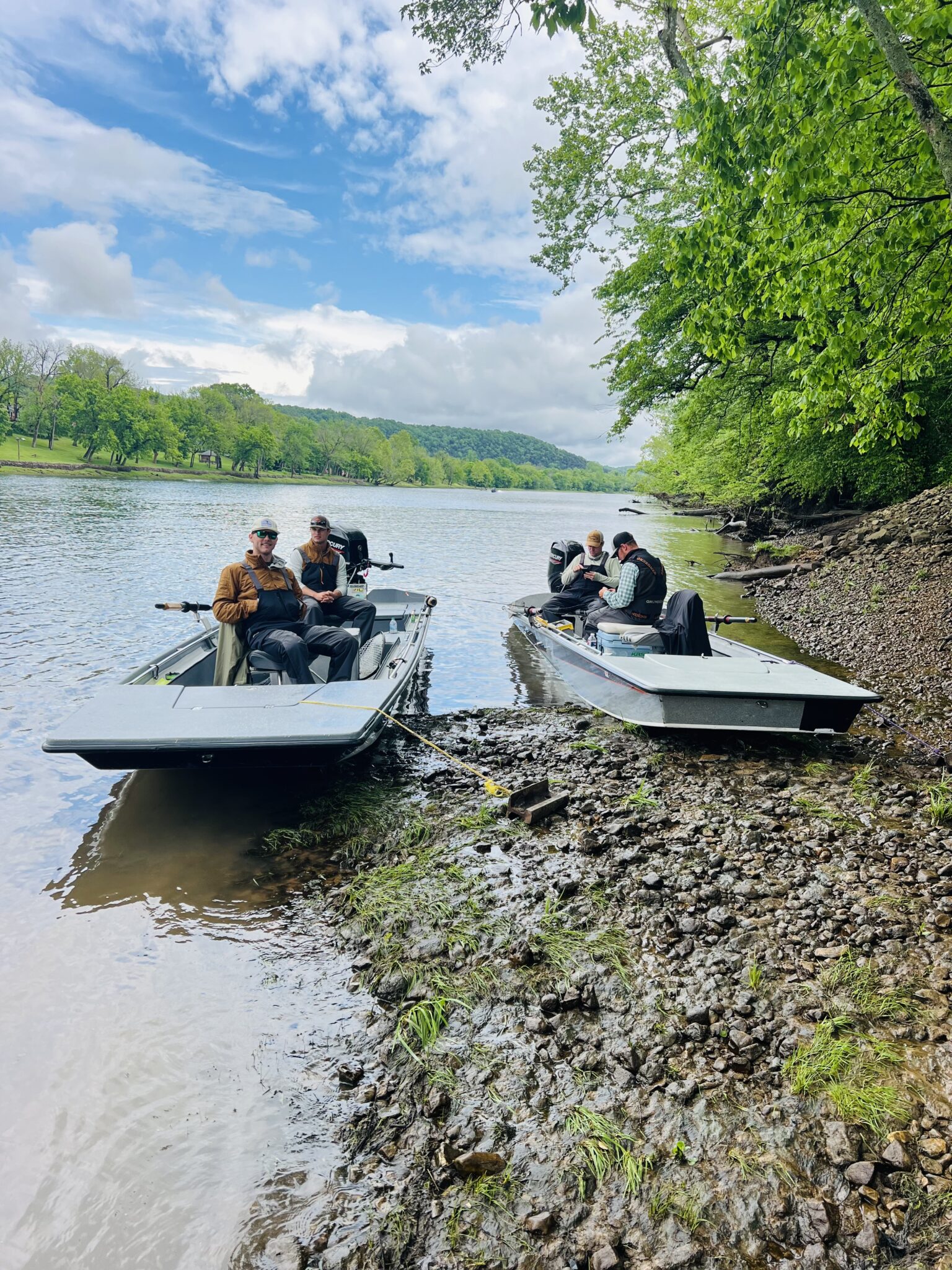 Two fly fishing guide boats pulled up on the bank of the White River in Arkansas.